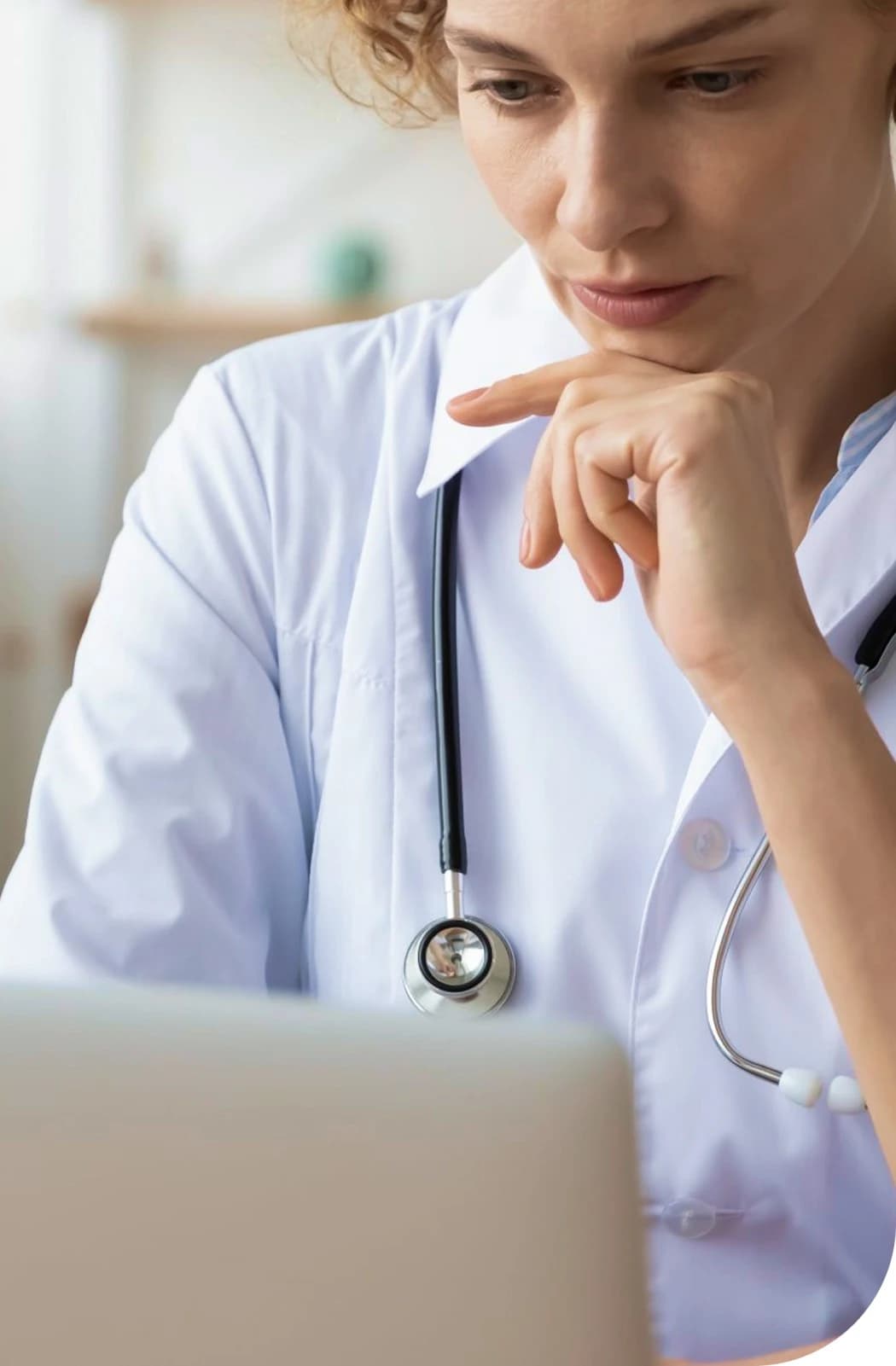 A wide web-optimized image featuring a patient receiving a comfortable, professional skin assessment or cosmetic procedure in a bright clinical setting